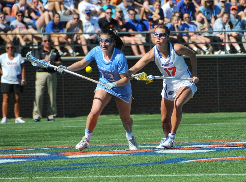 <p>UF attacker Mollie Stevens fights off a North Carolina player during Florida's 13-10 loss to the Tar Heels on Feb. 11, 2017, at Donald R. Dizney Stadium.</p>