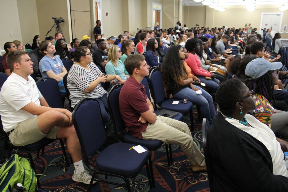 Around 250 people crowd the UF president's room at Emerson Hall for the town hall meeting with UF President Kent Fuchs on Monday. The town hall meeting focused on the relationship between the administration and diversity at UF.