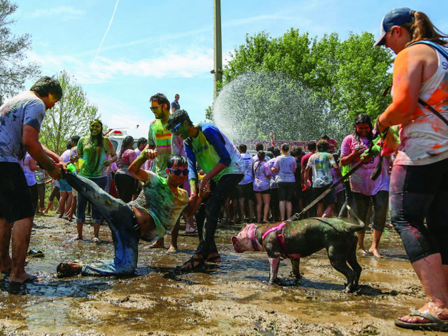 Participants of the 2017 UF Holi Festival of Colors, organized by the Indian Student Association and Student Government, have a mud fight on Sunday afternoon on Flavet Field. After the kickoff, people went under water thrown by a fire truck. 