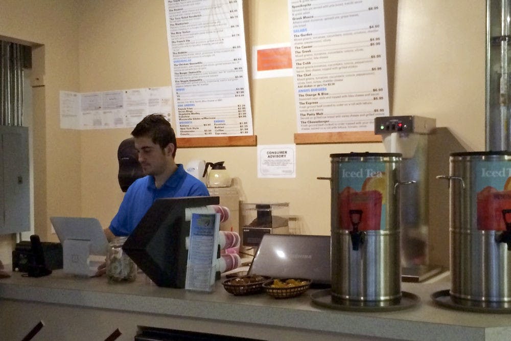 Redi Kola works in The Spot, the restaurant he opened over winter break with his cousin, Sairo. The restaurant, found in the Roberts’ Stadium Club in Midtown, serves Greek-American cuisine.