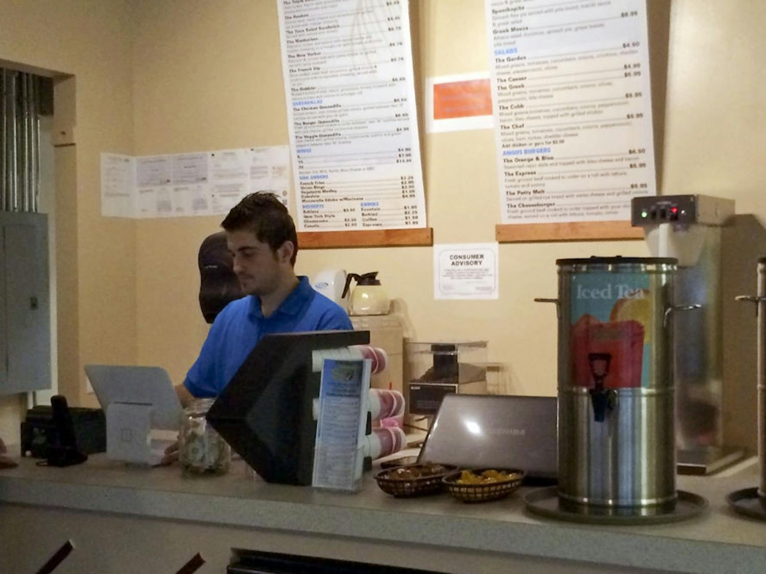 Redi Kola works in The Spot, the restaurant he opened over winter break with his cousin, Sairo. The restaurant, found in the Roberts’ Stadium Club in Midtown, serves Greek-American cuisine.