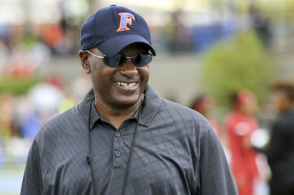 <p>UF coach Mike Holloway smiles during the 2015 Florida Relays at James G. Pressly Stadium.</p>