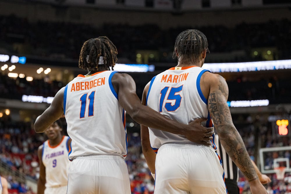 Florida Gators guard Denzel Aberdeen (11) embraces teammate Alijah Martin (15) during a basketball game against Norfolk State in the first round of the NCAA Tournament on Friday, March 21, 2025, in Raleigh, N.C.