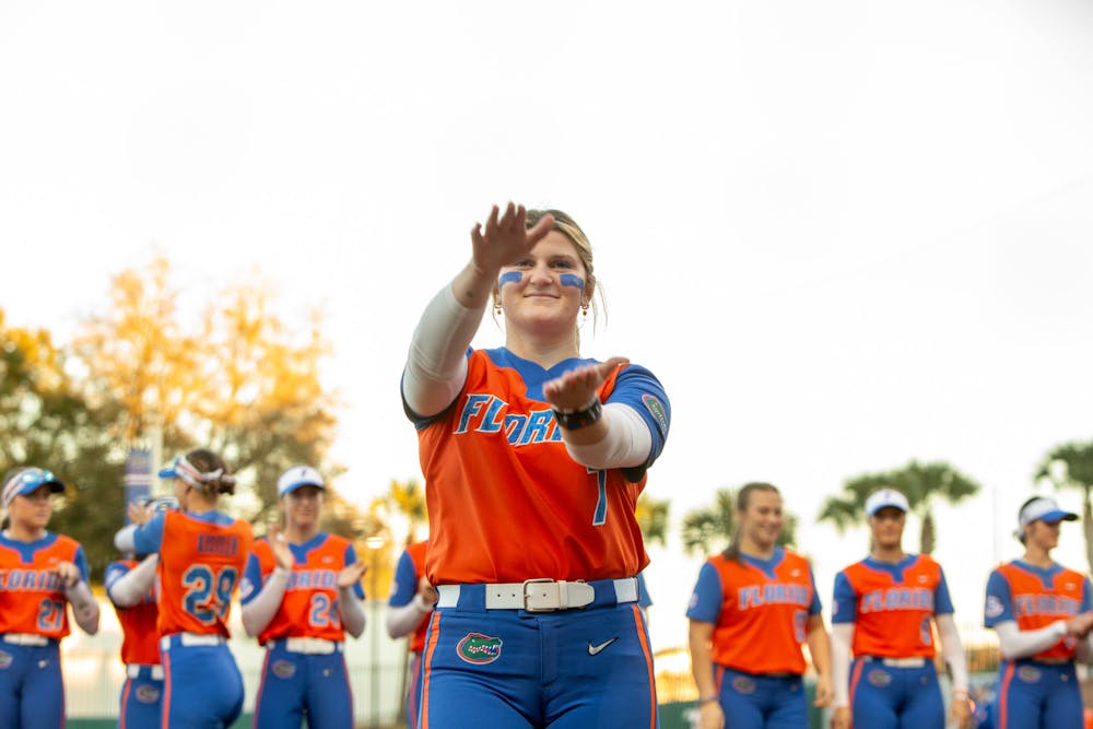 Gators softball pitcher Keagan Rothrock does the Gator chomp before the team's game against Oklahoma State on Monday, February 19, 2024. 