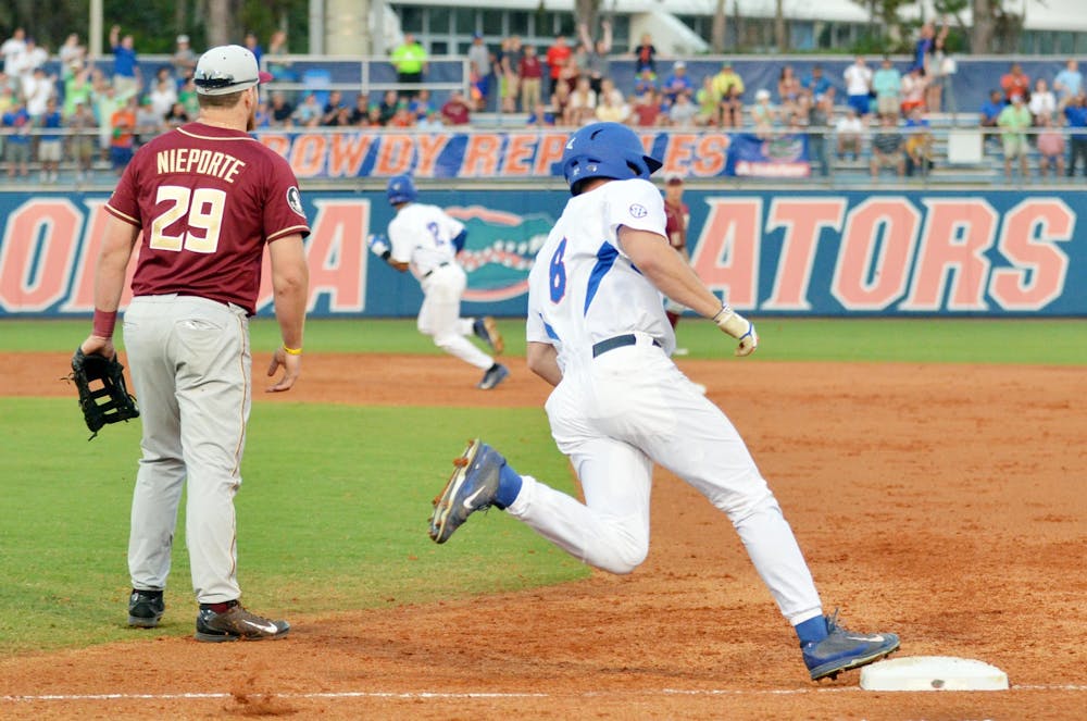 <p>Harrison Bader rounds first base after hitting an RBI triple in the first inning of Florida's 14-8 win against Florida State on Tuesday at McKethan Stadium.</p>