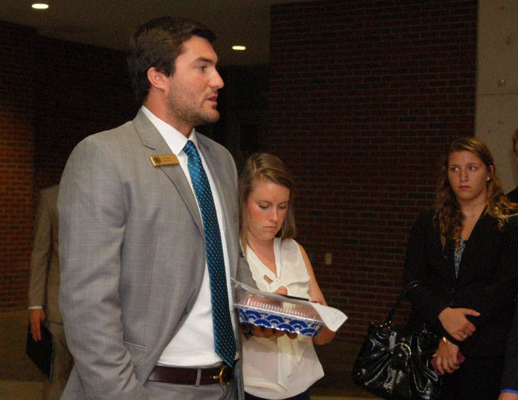 Sen. Davis Bean of the Swamp Party speaks informally to a group of party senators about low attendance outside the Chesterfield Smith room after the Senate meeting on Tuesday night.