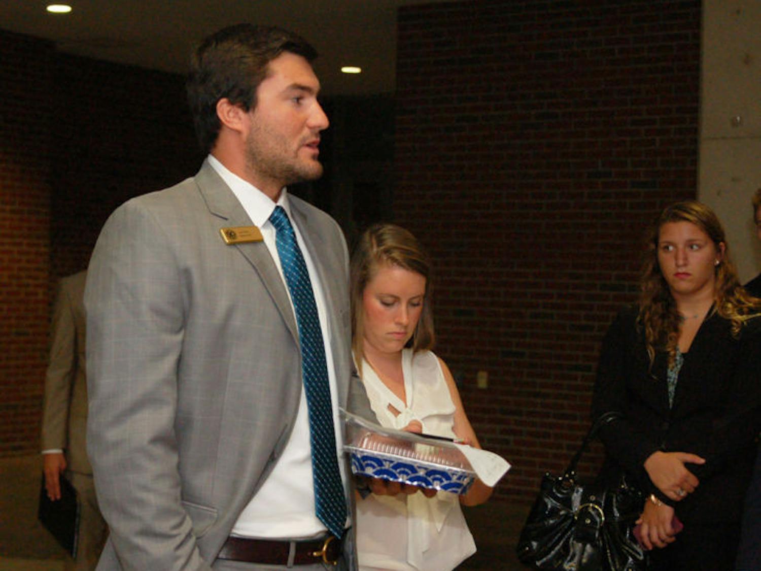 Sen. Davis Bean of the Swamp Party speaks informally to a group of party senators about low attendance outside the Chesterfield Smith room after the Senate meeting on Tuesday night.