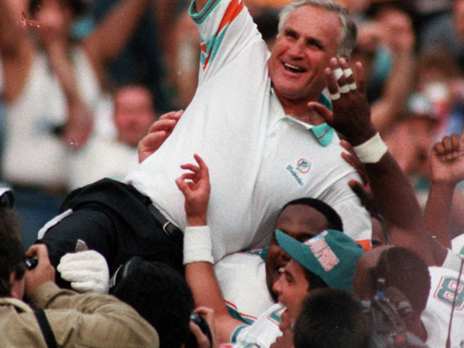 FILE - In this Nov. 14, 1993, file photo, Miami Dolphins coach Don Shula is carried on his team's shoulders after his 325th victory, at Philadelphia's Veterans Stadium. Shula, who won the most games of any NFL coach and led the Miami Dolphins to the only perfect season in league history, died Monday, May 4, 2020, at his home in Indian Creek, Fla., the team said. He was 90. (AP Photo/Amy Sancetta, File)