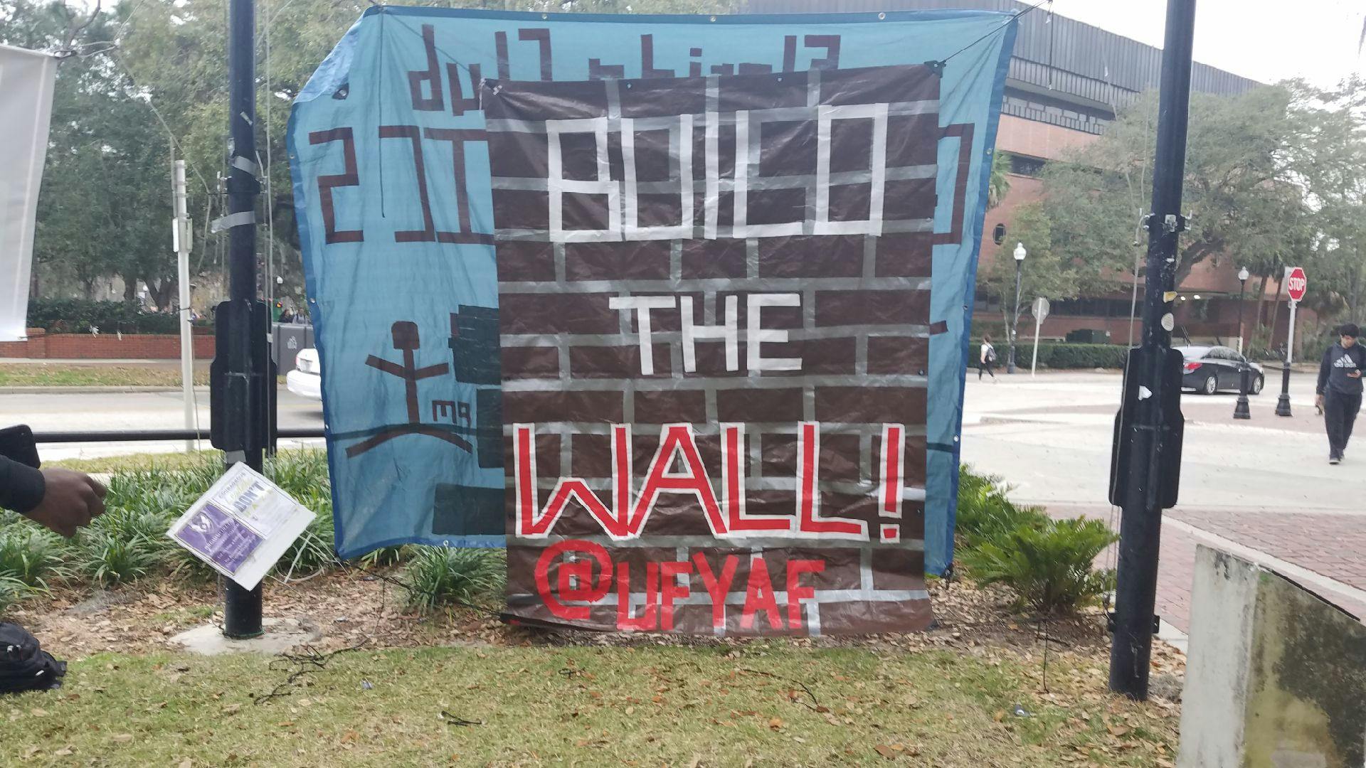 UF’s chapter of Young Americans for Freedom’s banner hangs on the Plaza of the Americas. The “Build the Wall” banner was removed three times.