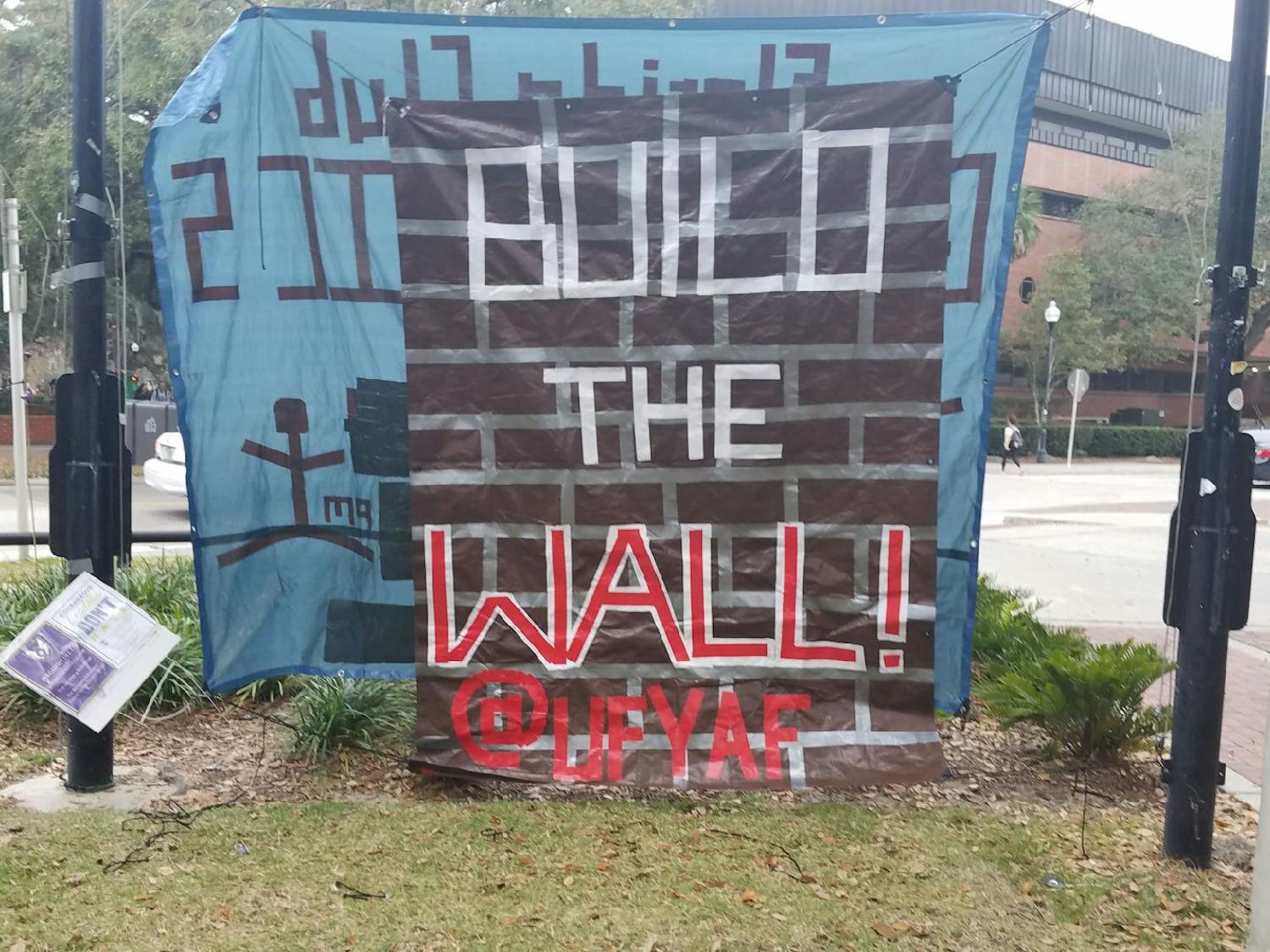 UF’s chapter of Young Americans for Freedom’s banner hangs on the Plaza of the Americas. The “Build the Wall” banner was removed three times.