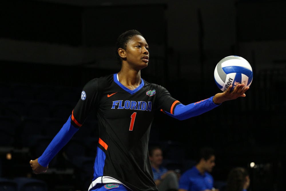 <p>UF middle blocker Rhamat Alhassan holds the ball during Florida's 3-0 win against Florida A&amp;M on Friday at the O'Connell Center.</p>