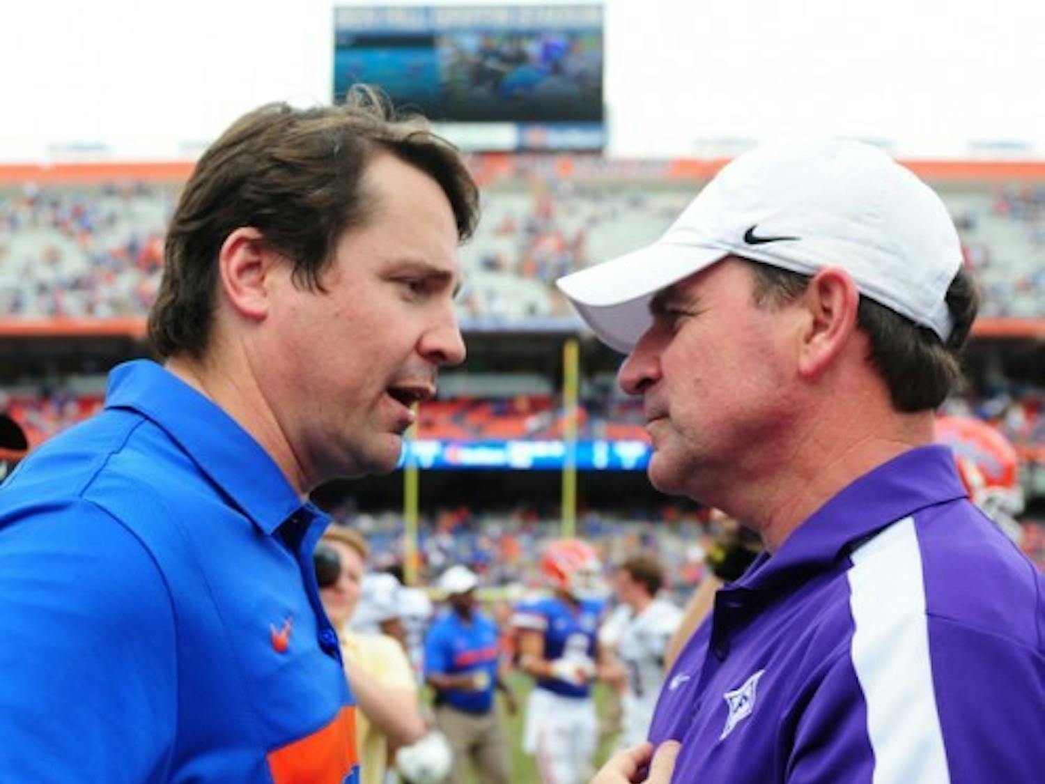 Florida coach Will Muschamp (left) said Furman coach Bruce Fowler (right) deserved credit for confusing the Gators’ defense in Saturday’s 54-32 win.