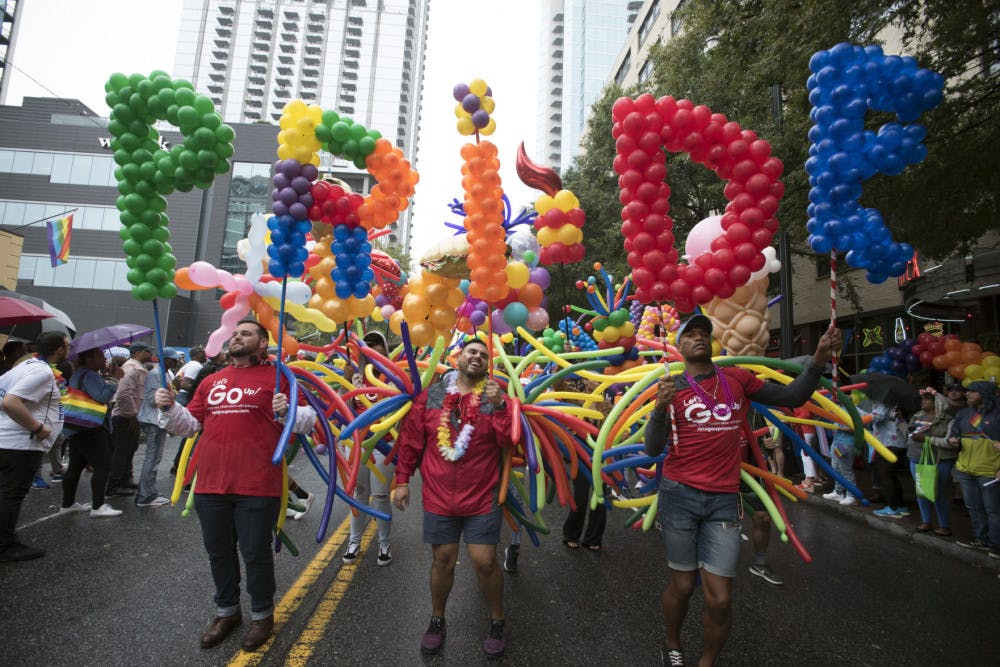 Employees from a local business supporting LGBTQ rights march during the city's annual Gay Pride parade on Sunday, Oct. 13, 2019, in Atlanta. (AP Photo/Robin Rayne)