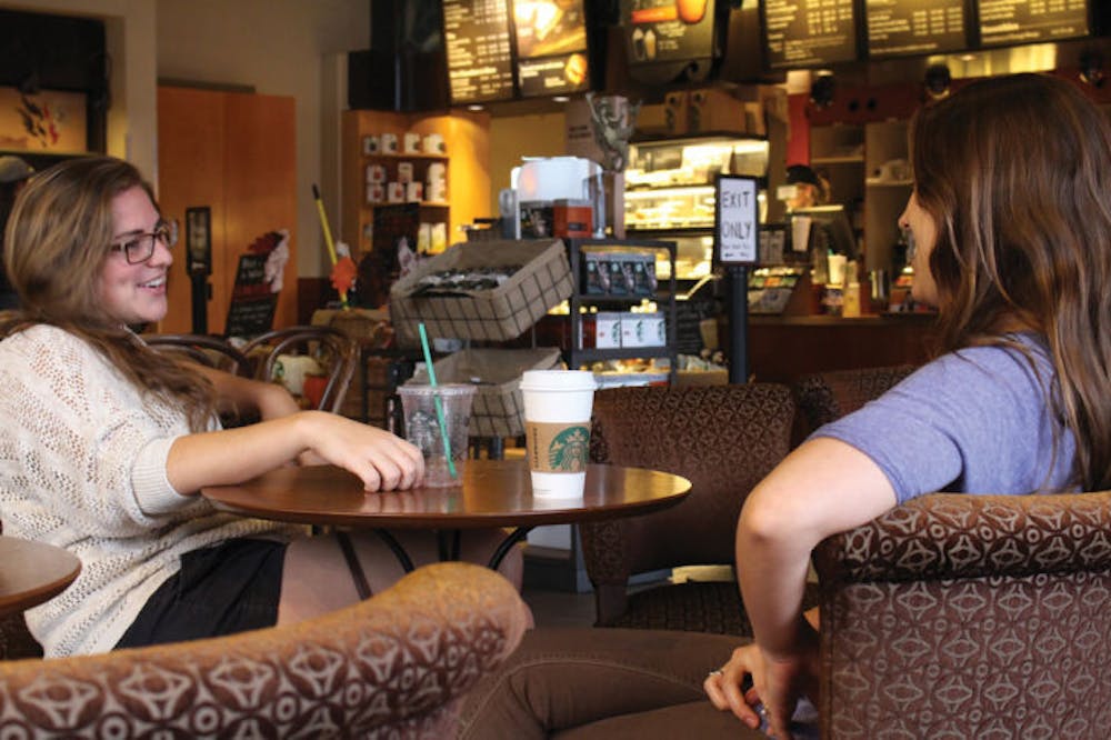 <p>UF economics senior Kerri Stern, 21, left, talks with Gainesville resident Sophie Ouellette-Howitz, 23, Monday at the downtown Starbucks. Starbucks recently asked customers not to bring firearms into its stores.</p>
