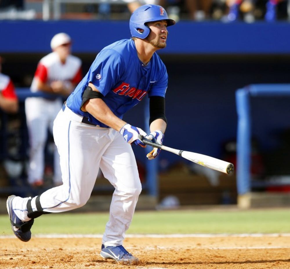 <p>Former Gators designated hitter Brian Johnson drops his bat after hitting a home run in a 9-8 win in 10 innings against the Wolfpack on June 10.</p>