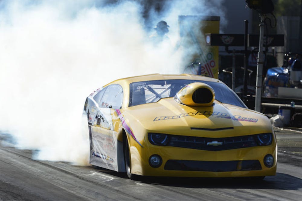 <p>Racecabinet.com driver Jim Greenheck performs a burnout during the 44th annual NHRA Gatornationals at Auto Plus Raceway Gainesville on Saturday.</p>