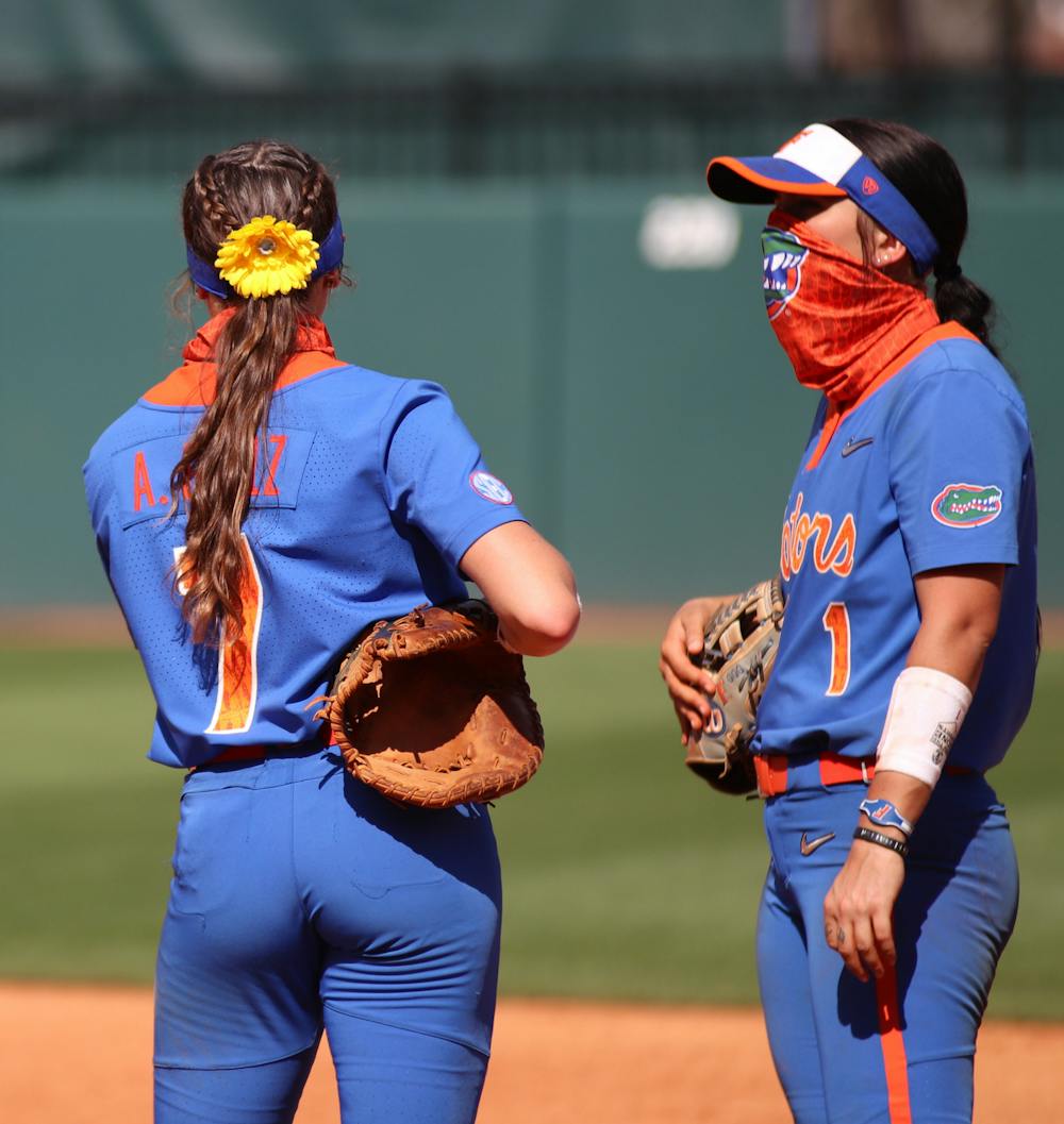Infielders Hannah Adams and Avery Golez discuss strategy during an on-field timeout against Louisville, 2021