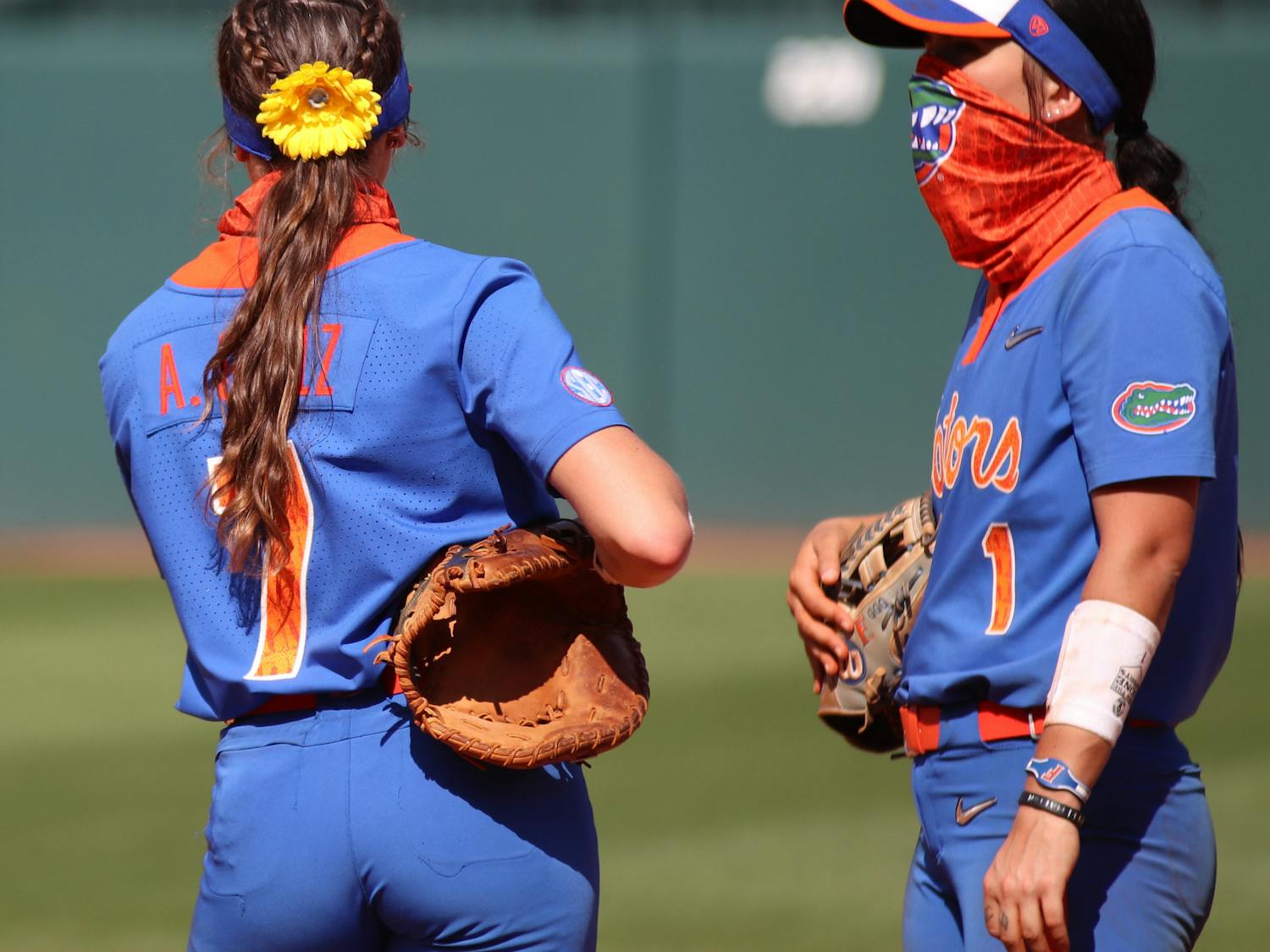 Infielders Hannah Adams and Avery Golez discuss strategy during an on-field timeout against Louisville, 2021