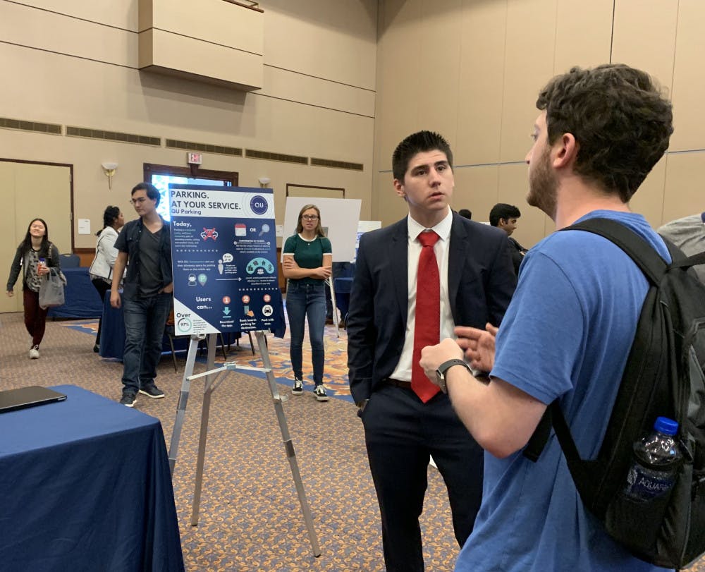 Health science senior Daniel Valladares, 22, answers questions about his business idea for a parking service app called “QU Parking.” 