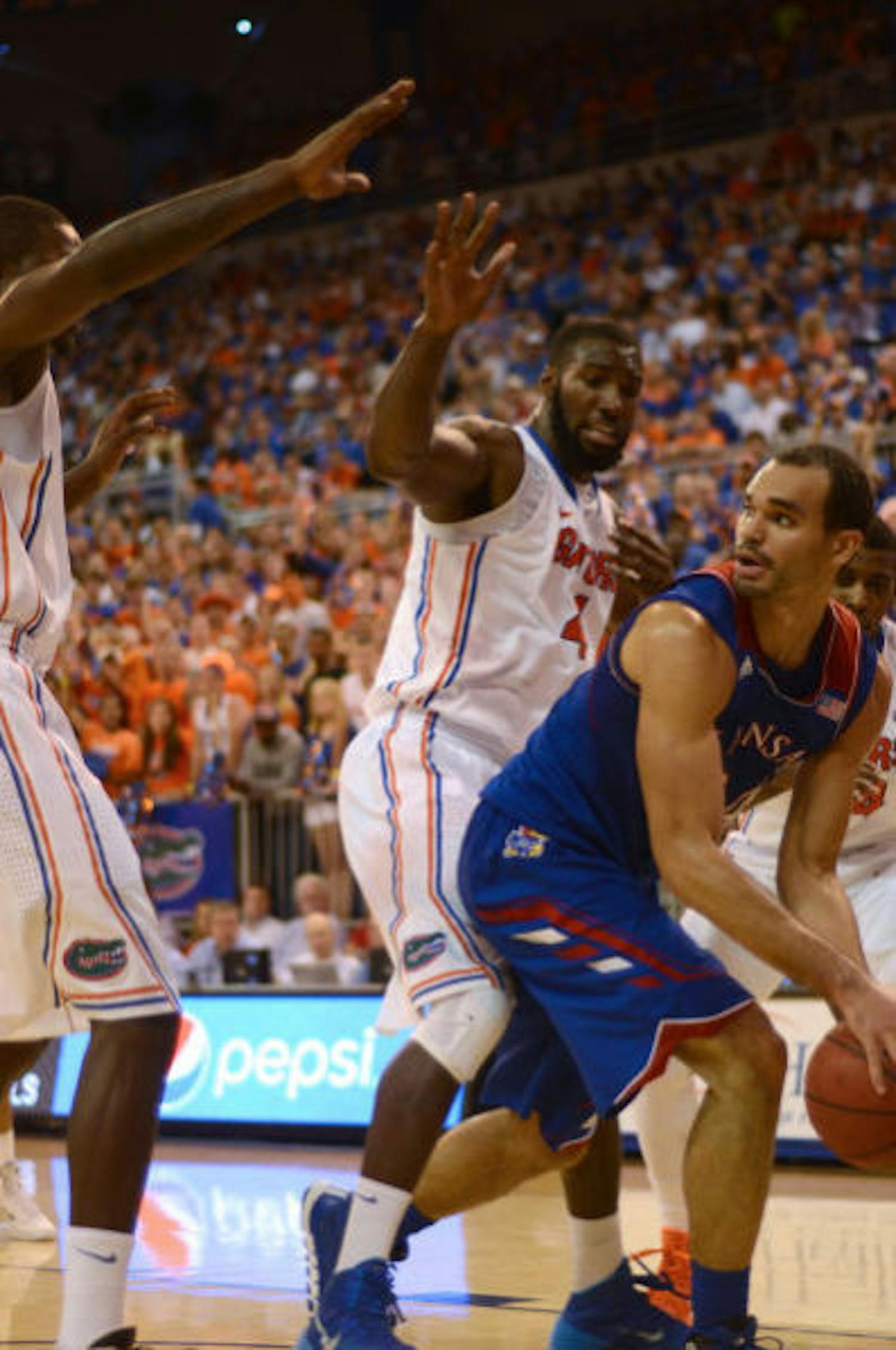 Gators senior center Patric Young (4) defends Kansas forward Perry Ellis during No. 19 Florida's 67-61 win against No. 13 Kansas on Tuesday night in the O'Connell Center.