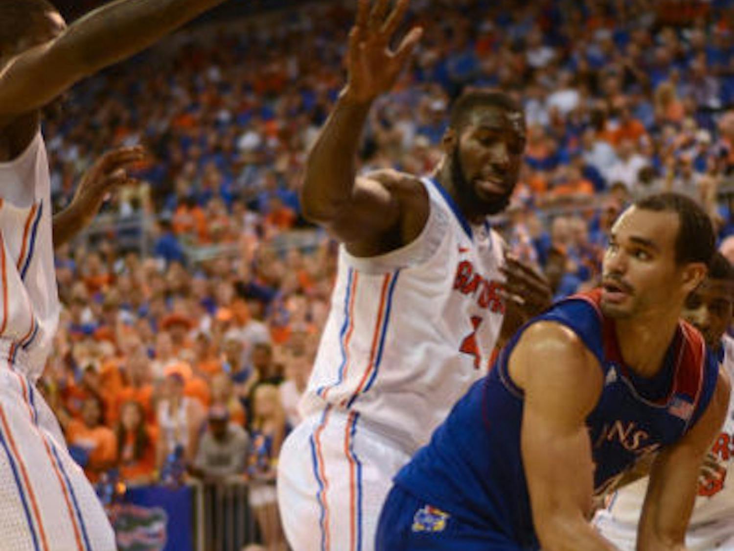 Gators senior center Patric Young (4) defends Kansas forward Perry Ellis during No. 19 Florida's 67-61 win against No. 13 Kansas on Tuesday night in the O'Connell Center.