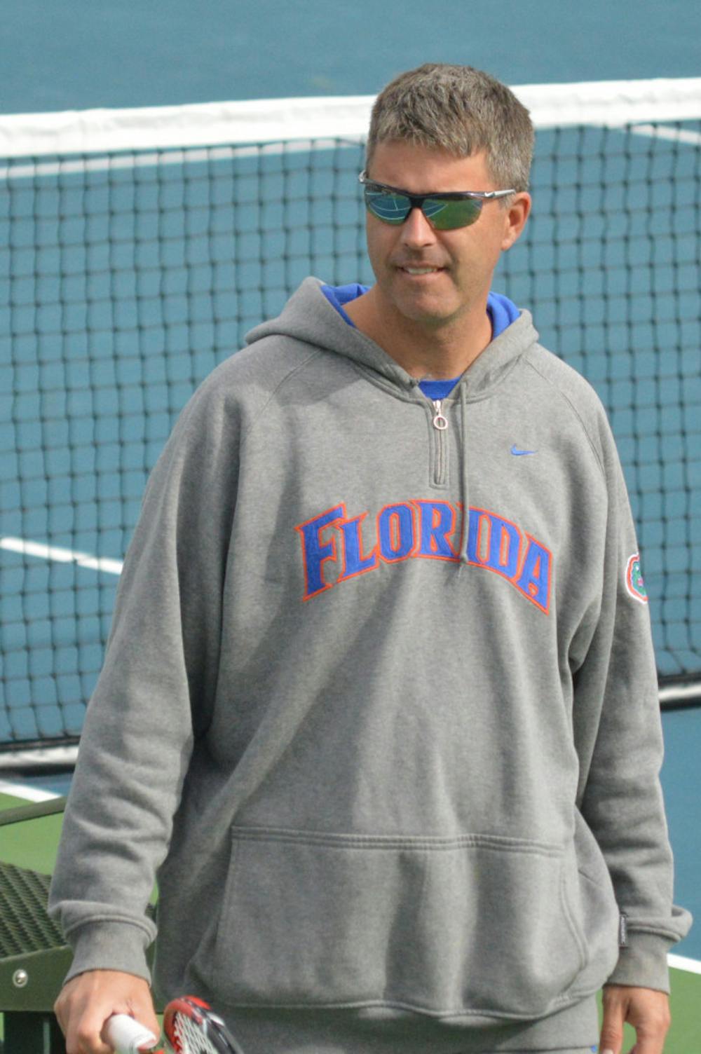 <p>Coach Roland Thornqvist looks down the courts of the Ring Tennis Complex during Florida's 4-0 win against Louisville on Aug. 25.</p>
