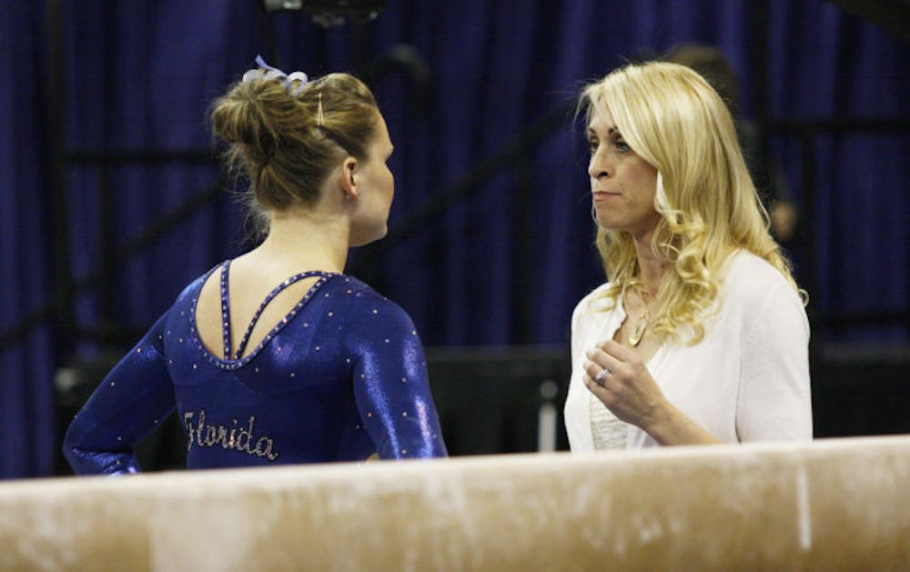 <p>Coach Rhonda Faehn talks to freshman Bridget Sloan before her performance on beam during Florida’s 197.3-194.625 victory against Missouri on Jan. 18 in the O’Connell Center.</p>