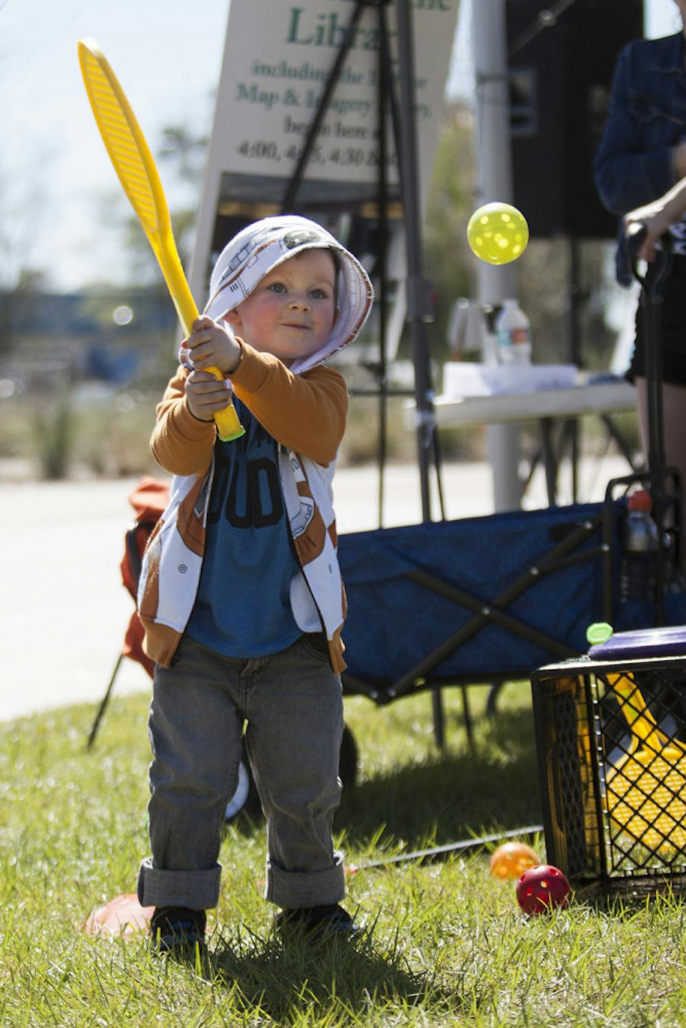 <p dir="ltr"><span>Killian Pennell, 3, plays with a Wiffle ball at the YMCA booth during Active Streets Gainesville at Depot Park on Sunday. Killian's dad, Kyle Pennell, said this is Killian's second time coming to Active Streets Gainesville.</span></p><p><span> </span></p>