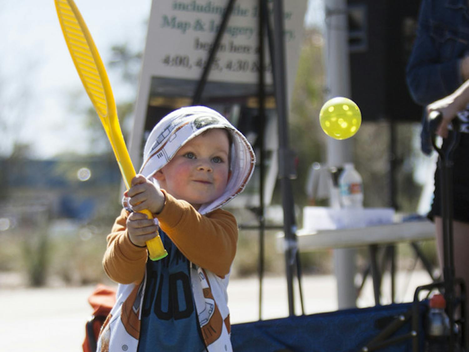 Killian Pennell, 3, plays with a Wiffle ball at the YMCA booth during Active Streets Gainesville at Depot Park on Sunday. Killian's dad, Kyle Pennell, said this is Killian's second time coming to Active Streets Gainesville.