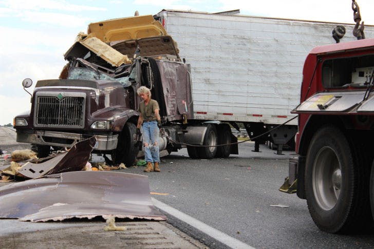 University Towing &amp; Transport Inc. worker Jerry Bailey prepares to tow a semitruck after an accident that left the truck overturned, blocking all three northbound lanes on Interstate 75 near the Micanopy exit on Saturday afternoon.