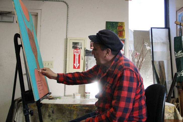 Local artist Marco Razo, 50, puts some finishing touches on his latest painting at Sweetwater Print Co-Op, 117 S. Main St., Saturday afternoon. His new exhibition, Meditaciones de un Quijote (Meditations of a Quixote), is opening Feb. 19 at the Hippodrome Gallery, 25 SE Second Place.