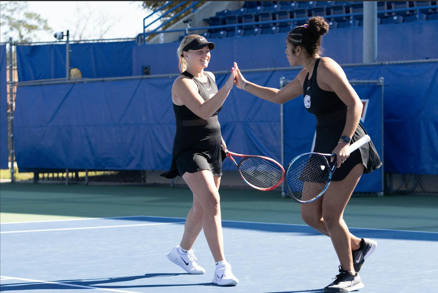 Florida’s pair of freshmen Malwina Rowinska (left) and Qavia Lopez (right) celebrate winning a doubles point in the Gators women’s tennis match against Baylor on Tuesday, February, 6, 2024.