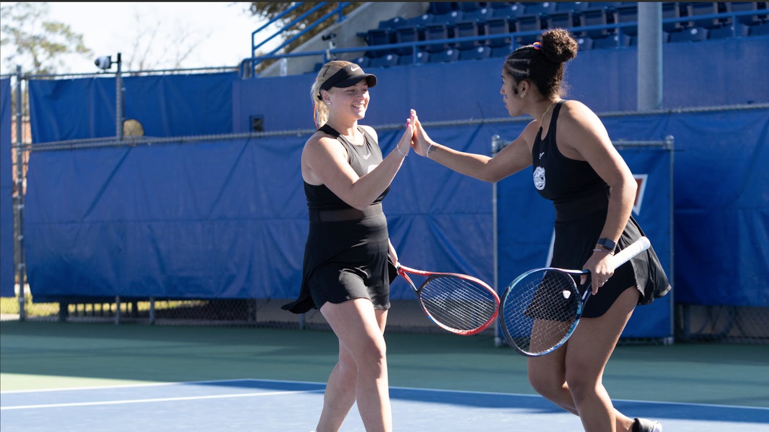 Florida’s pair of freshmen Malwina Rowinska (left) and Qavia Lopez (right) celebrate winning a doubles point in the Gators women’s tennis match against Baylor.