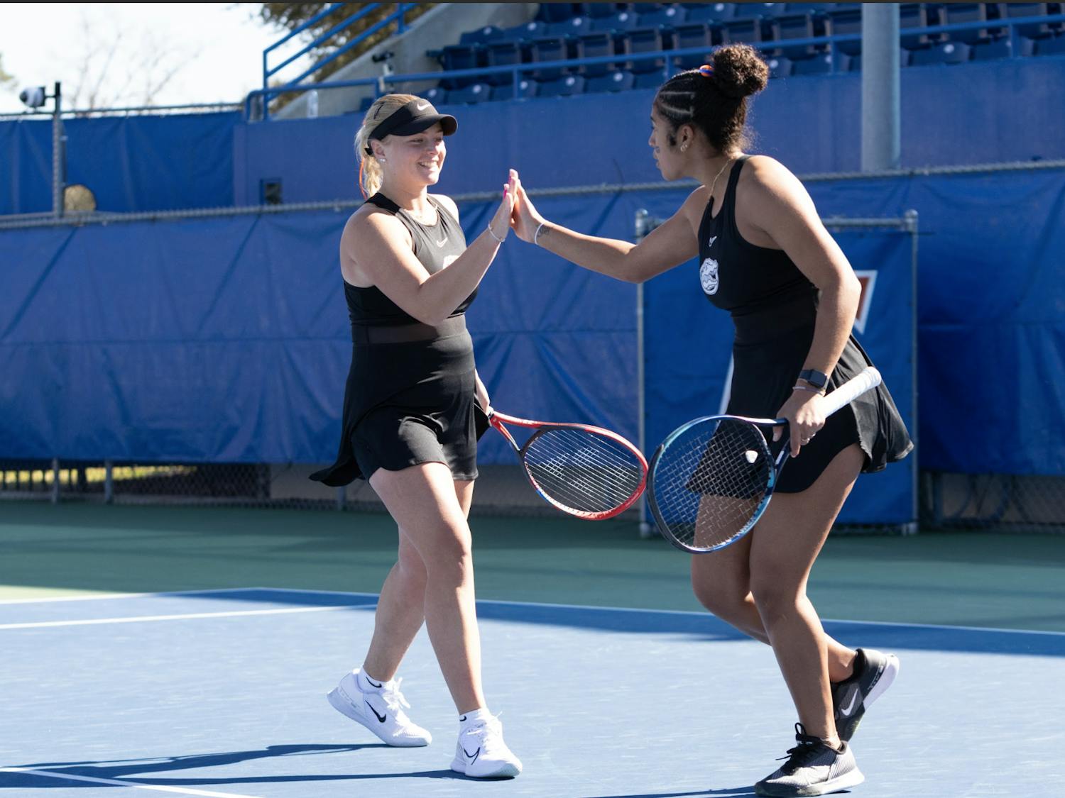 Florida’s pair of freshmen Malwina Rowinska (left) and Qavia Lopez (right) celebrate winning a doubles point in the Gators women’s tennis match against Baylor on Tuesday, February, 6, 2024.