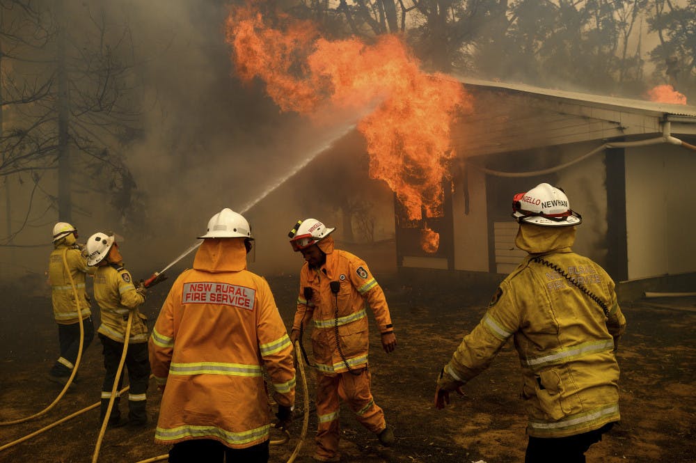 <p>Firefighters battle the Morton Fire as it burns a home near Bundanoon, New South Wales, Australia, on Thursday, Jan. 23, 2020. (AP Photo/Noah Berger)</p>