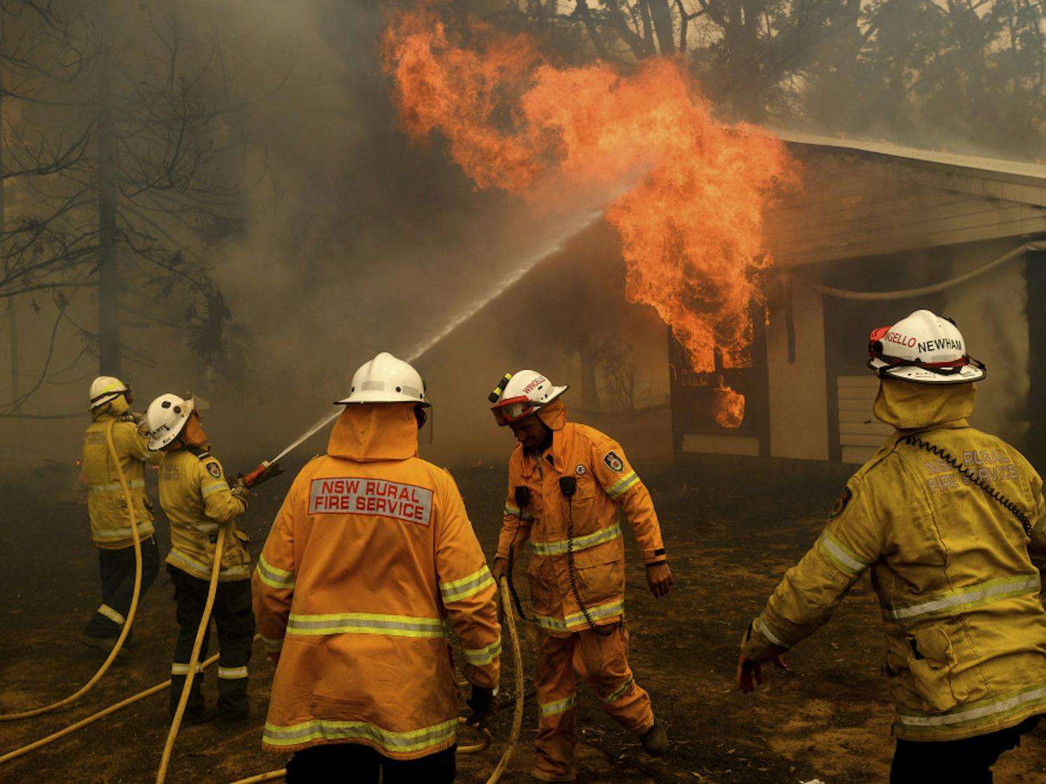 Firefighters battle the Morton Fire as it burns a home near Bundanoon, New South Wales, Australia, on Thursday, Jan. 23, 2020. (AP Photo/Noah Berger)