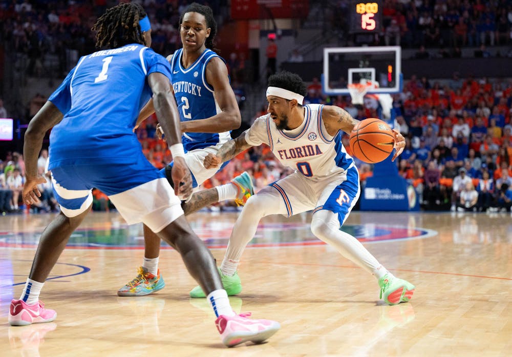 Florida guard Boogie Fland (0)  dribbles against Kentucky guard Denzel Aberdeen (1) during the first half of an NCAA college basketball game, Saturday, Feb. 14, 2026 at Exactech Arena in Gainesville, Fla.