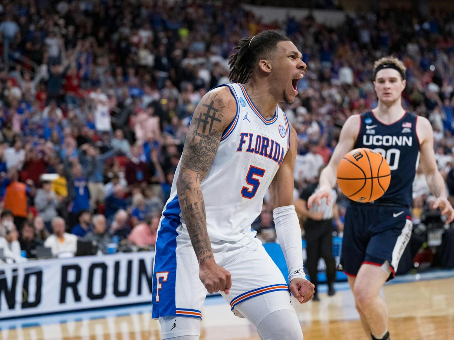Florida Gators guard Will Richard (5) celebrates after a dunk during a basketball game against UConn in the second round of the NCAA Tournament on Sunday, March 23, 2025, in Raleigh, N.C.