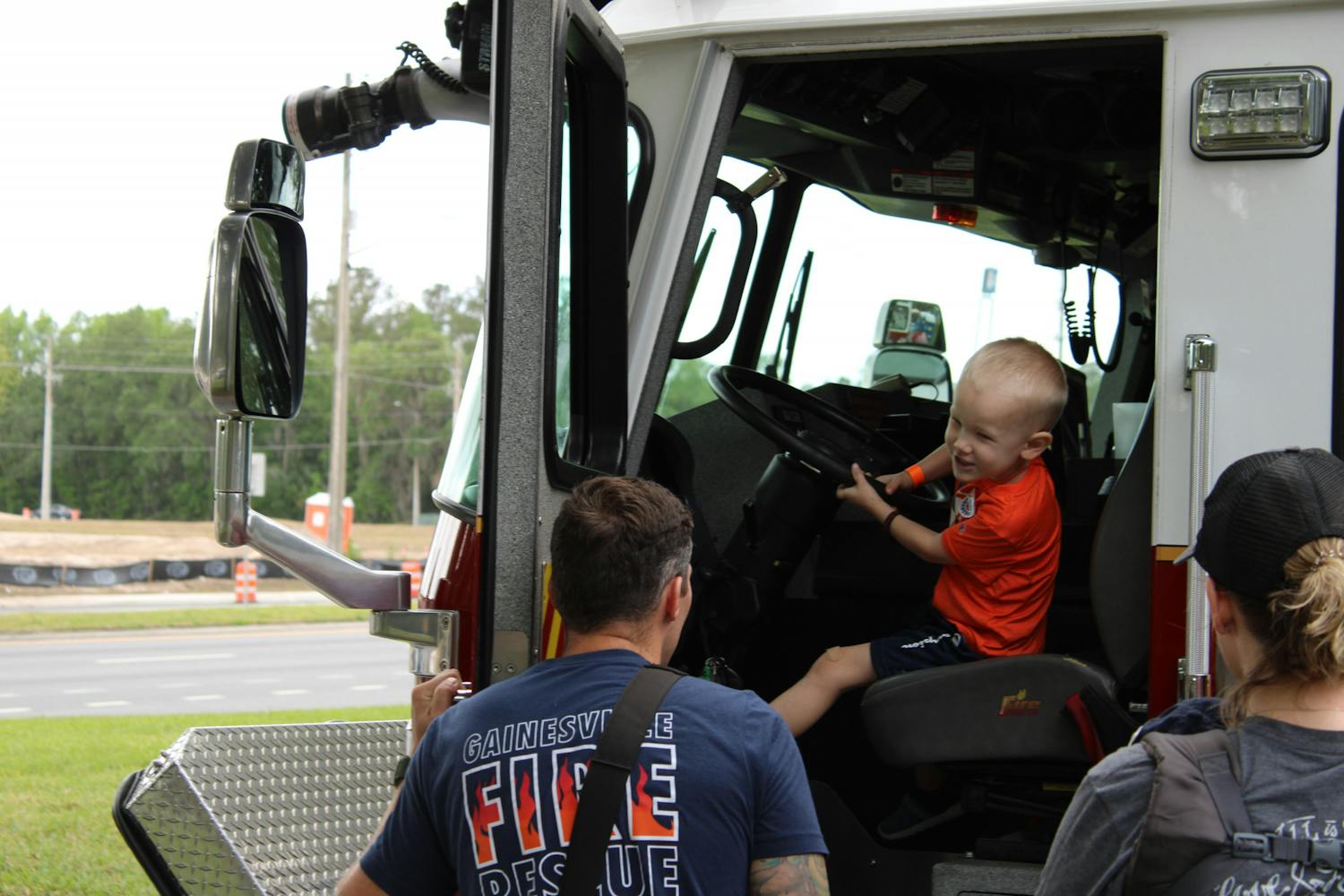 Kolson Langford, 4, sits in the front seat of one of Gainesville Fire Rescue&#x27;s fire truck at the at the Bike Rodeo, Safety and Health Fair hosted by UF Health Shands Children’s Hospital on Saturday, March 25, 2023.