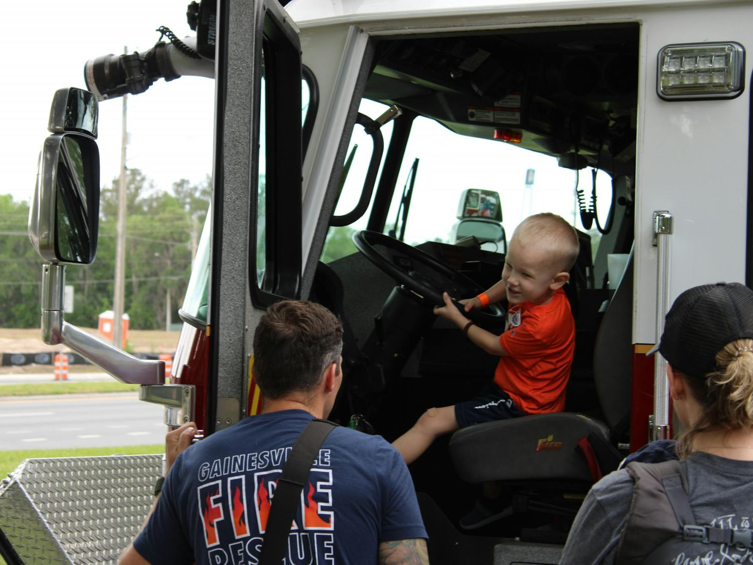 Kolson Langford, 4, sits in the front seat of one of Gainesville Fire Rescue&#x27;s fire truck at the at the Bike Rodeo, Safety and Health Fair hosted by UF Health Shands Children’s Hospital on Saturday, March 25, 2023.
