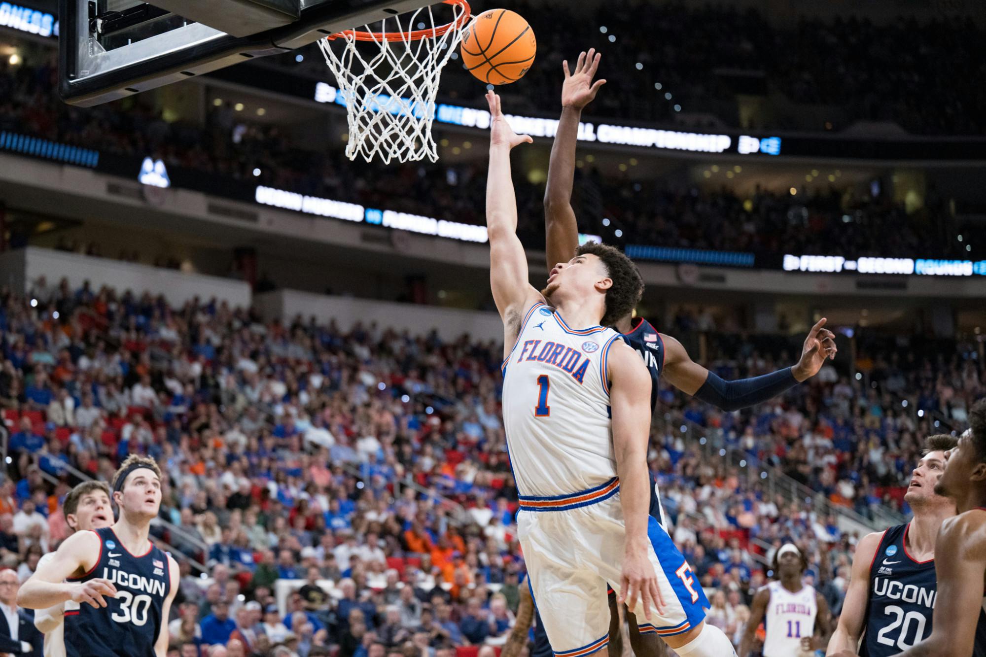 Florida Gators guard Walter Clayton Jr. (1) takes a layup during a basketball game against UConn in the second round of the NCAA Tournament on Sunday, March 23, 2025, in Raleigh, N.C.