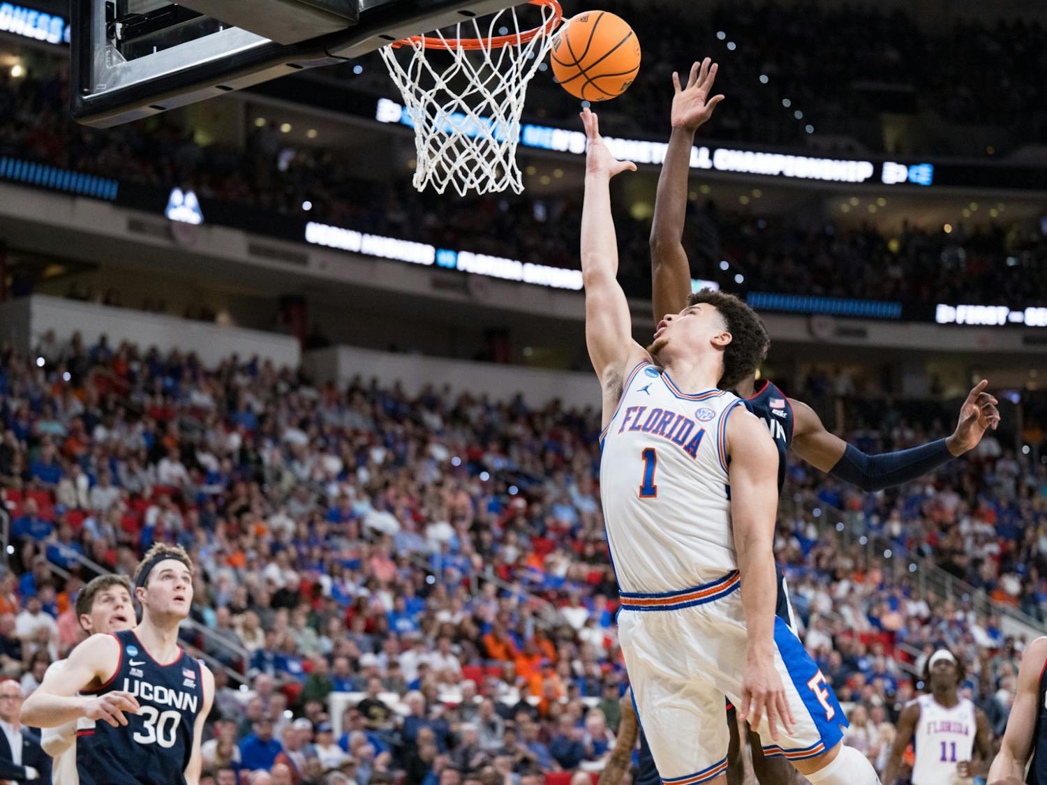 Florida Gators guard Walter Clayton Jr. (1) takes a layup during a basketball game against UConn in the second round of the NCAA Tournament on Sunday, March 23, 2025, in Raleigh, N.C.