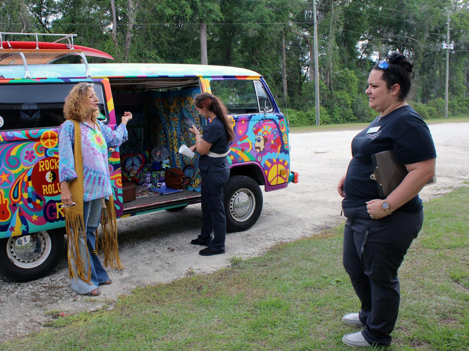 Elaine Hargrove (left) shows off her hand-painted 1978 Volkswagen bus to Tri-County Nursing Home staff on on Tuesday, April 11, 2023. Crystal Ellison (right) invites Hargrove to perform for the residents once a month.