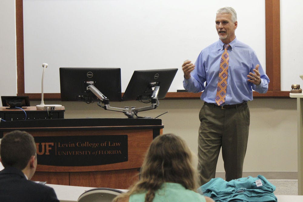 Florida State Rep. Keith Perry discusses how government regulation of business helps the consumer at Tuesday evening’s Student Senate meeting.