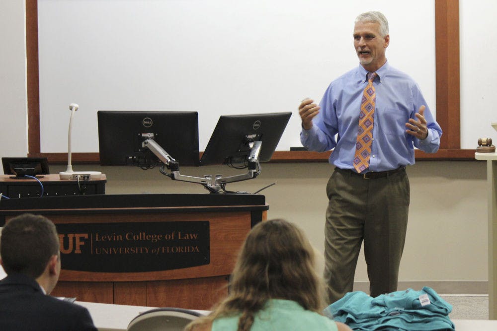 <p class="p1">Florida State Rep. Keith Perry discusses how government regulation of business helps the consumer at Tuesday evening’s Student Senate meeting.</p>