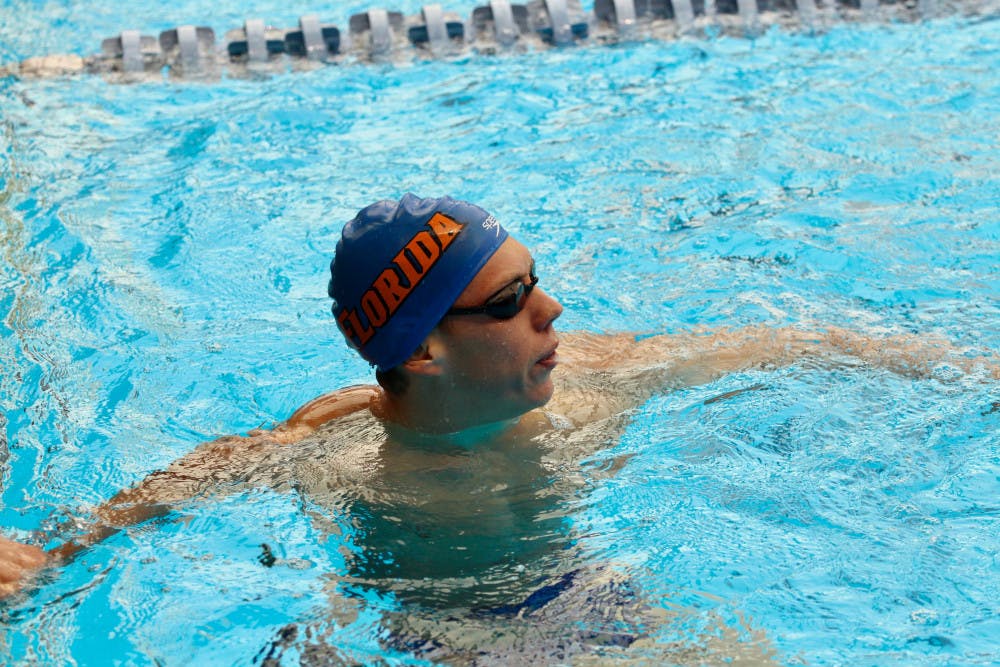 UF swimmer Jan Switkowski won three individual competitions to help the Gators men's swimming and diving team beat Georgia on Friday for the first time since 2013.