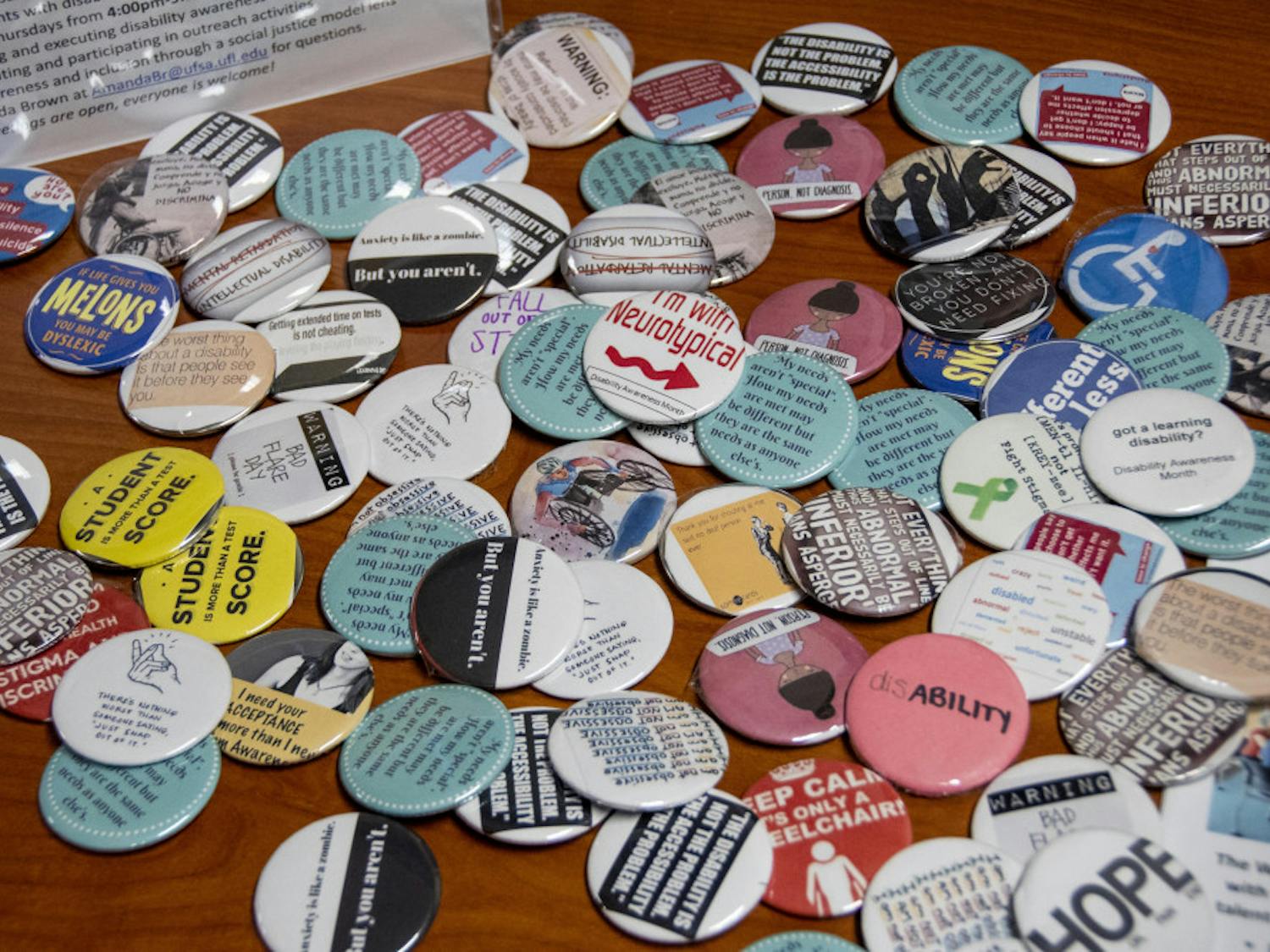 Pins are passed out with words of encouragement at the UF Disability Advocacy Assembly Thursday night. The event, which aimed towards building a more inclusive and aware campus, took place at Cypress Hall.