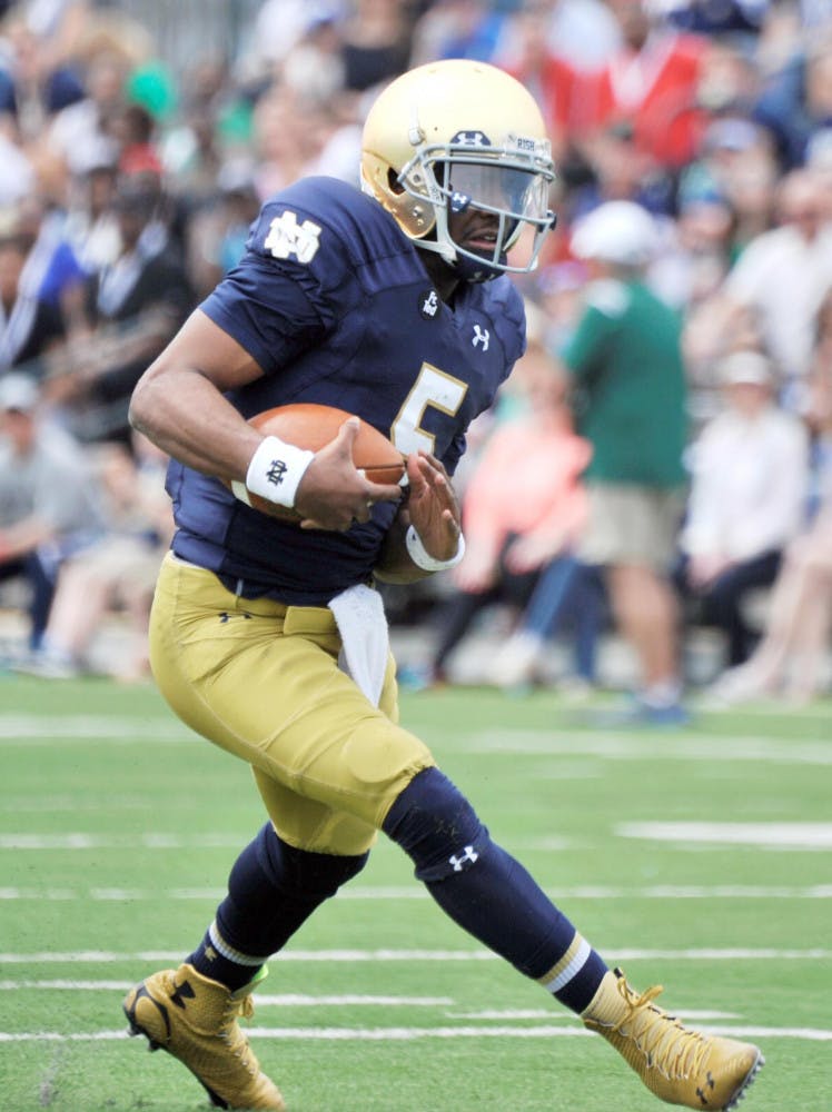 Notre Dame quarterback Everett Golson (5) sprints into the end zone during the Blue Gold spring NCAA college football game, Saturday April 18, 2015 in South Bend, Indiana.