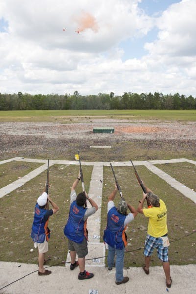 The Florida Gator Trap, Skeet and Sporting Team takes aim at a clay disk filled with orange powder at the Gator Skeet and Trap Club last Tuesday.