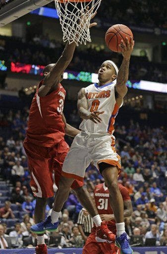 Florida's Kasey Hill (0) drives against Arkansas's Moses Kingsley (33) during the second half of an NCAA college basketball game in the Southeastern Conference tournament in Nashville, Tenn., Thursday, March 10, 2016. Florida won 68-61. (AP Photo/Mark Humphrey)